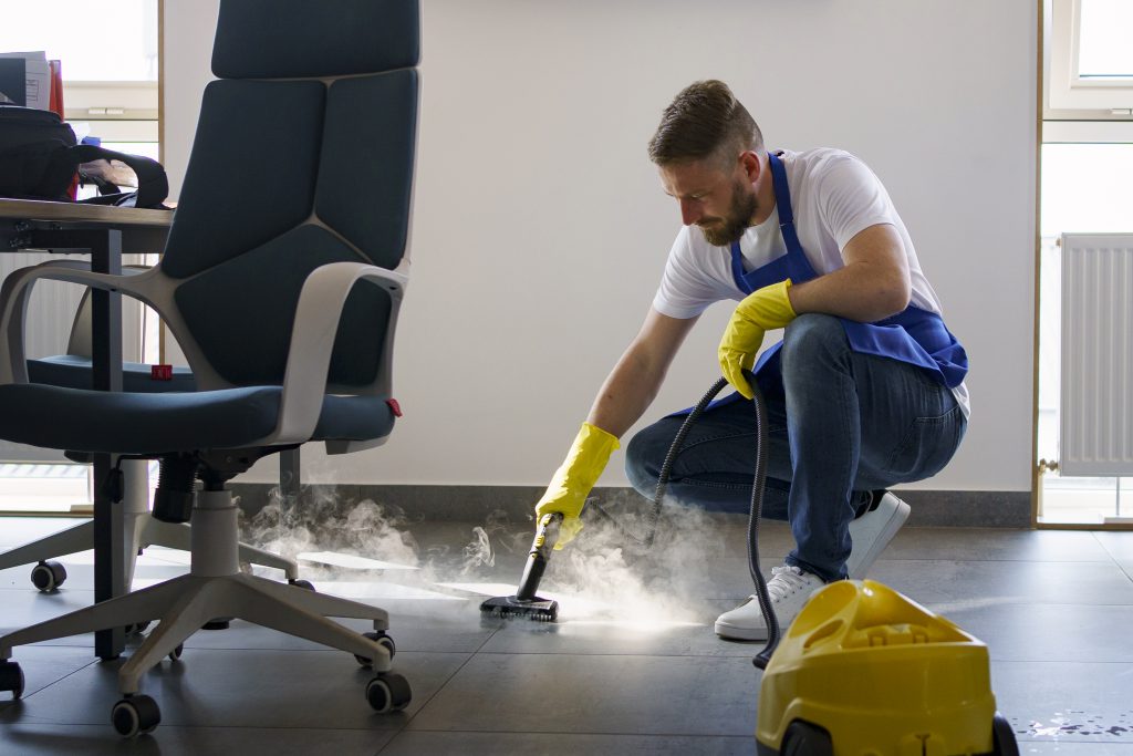 professional-cleaning-service-person-using-steam-cleaner-office